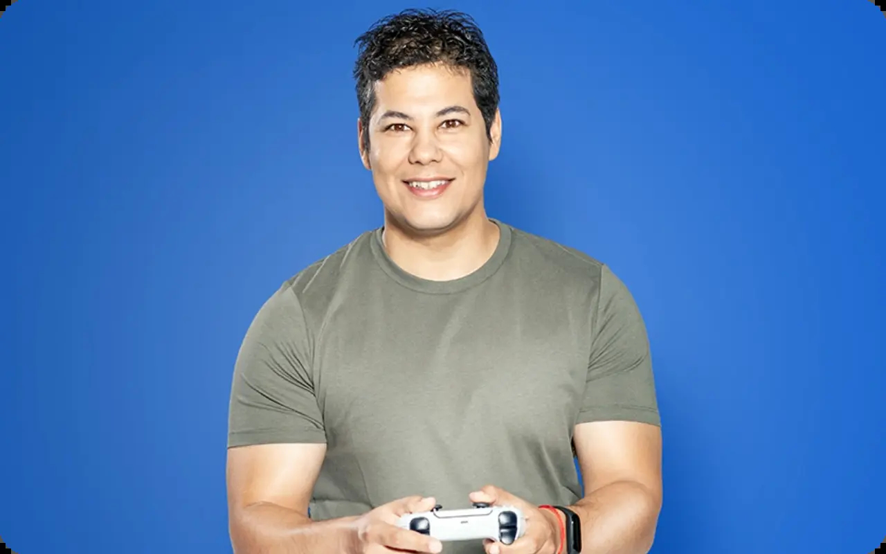 Stefan Georgiev from Amusnet smiling with a joystick for our hiring and careers website